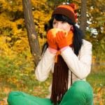 Young pretty woman with tea cup in the autumn park